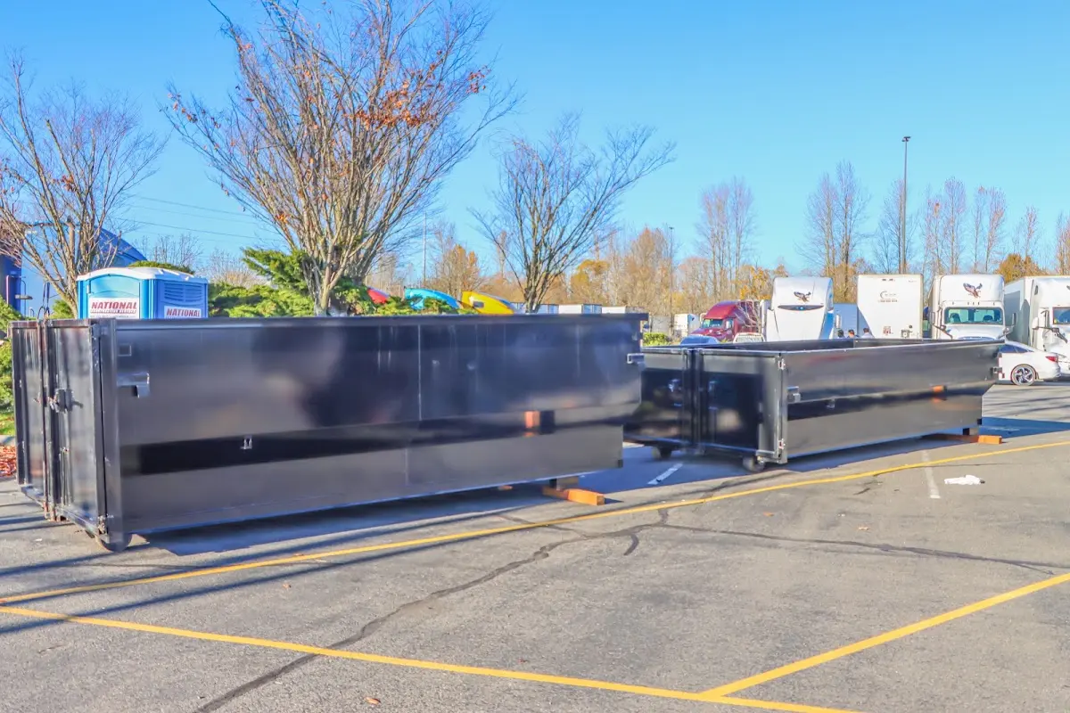 Professional dumpster rental service with roll-off container on residential driveway in Little River